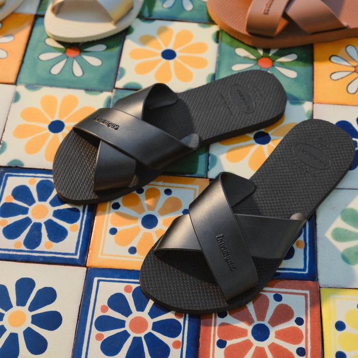 black havaianas sandals on a colorful tile floor