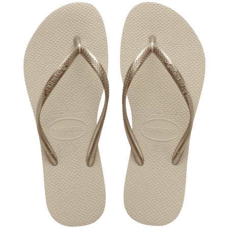 Women's beige flip flops with gold straps, top view