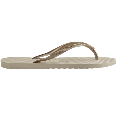 Women's beige flip flops with gold straps, side view