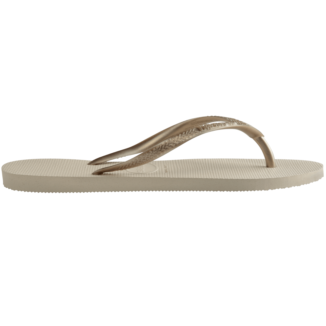 Women's beige flip flops with gold straps, side view