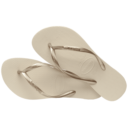 Women's beige flip flops with gold straps, alternate top view