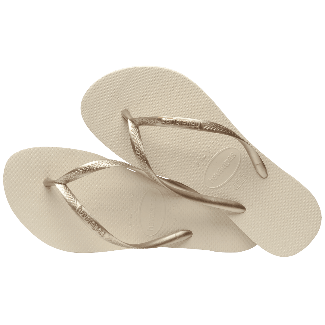 Women's beige flip flops with gold straps, alternate top view