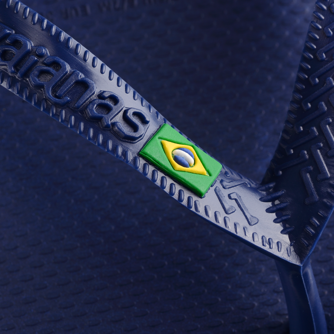 Navy blue women's flip flop with Brazil flag on strap detail view