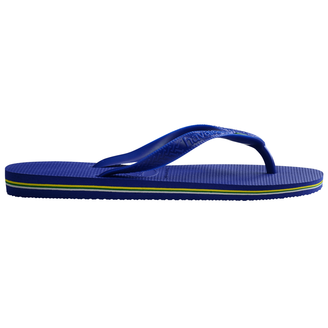 Women's cobalt blue flip flop with Brazil flag detail on the straps, side view