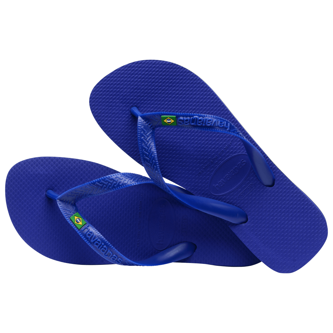 Women's cobalt blue flip flop with Brazil flag detail on the straps, alternate top view