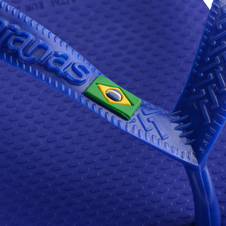 Women's cobalt blue flip flop with Brazil flag detail on the straps, detail view