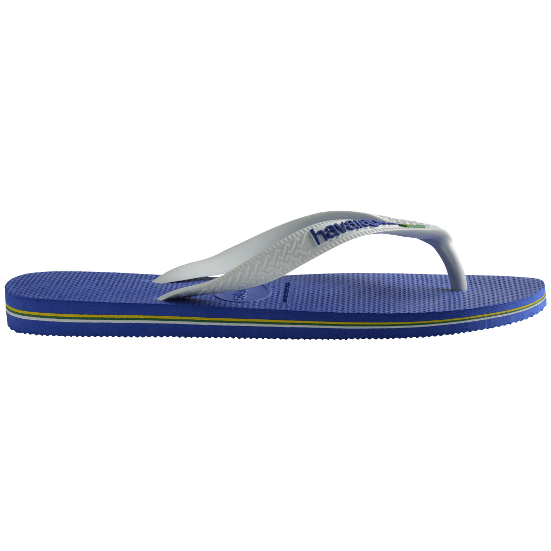 Kids' cobalt blue flip flop with white straps and Brazil flag detail, side view