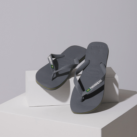 Kids' grey flip flop with Brazil flag detail on the strap, lifestyle image