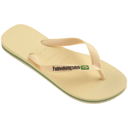 light yellow flip flops with yellow straps that say havaianas in brown, and a brazil flag,front right view