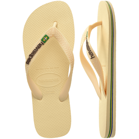 light yellow flip flops with yellow straps that say havaianas in brown, and a brazil flag, one shoe top view, one shoe side view