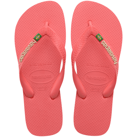 coral pink flip flops with pink straps that feature a small brazil flag, top view