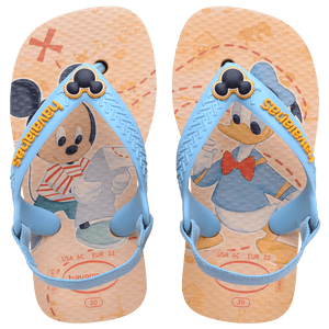 baby sandals with mickey mouse and donald duck on a yellow background with blue straps and a mickey mouse charm, top view