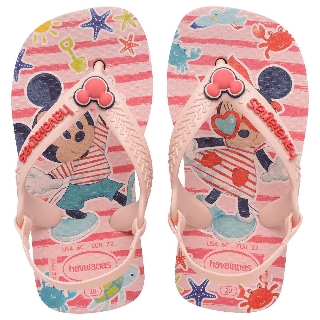 baby sandal with mickey and minnie mouse on pink background with sea creatures and a mickey mouse charm on the pink strap, top view