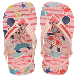 baby sandal with mickey and minnie mouse on pink background with sea creatures and a mickey mouse charm on the pink strap, top view