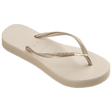 beige platform flip flop, with a darker beige colored midlayer between the sole and bottom of the flip flop, beige metallic straps, front right view