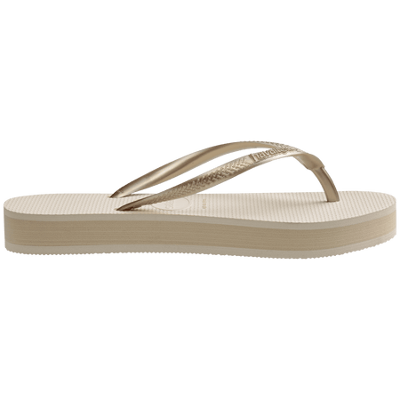 beige platform flip flop, with a darker beige colored midlayer between the sole and bottom of the flip flop, beige metallic straps, side view