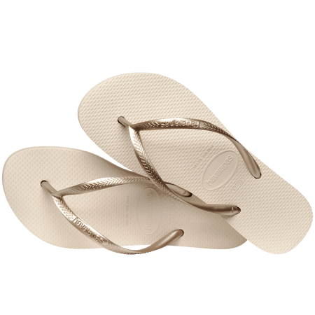 beige platform flip flop, with a darker beige colored midlayer between the sole and bottom of the flip flop, beige metallic straps, flip flops laying on top of eachother, top view