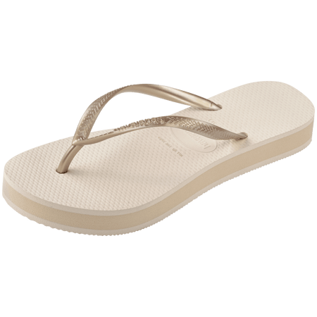 beige platform flip flop, with a darker beige colored midlayer between the sole and bottom of the flip flop, beige metallic straps, front left view