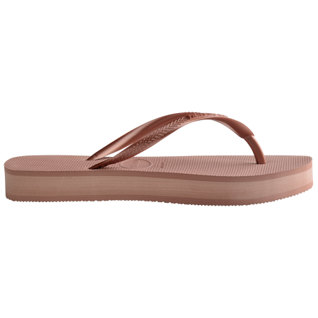 light pink flip flops with a platform and a pink metallic strap, side view, two toned pink layer between sole and bottom of shoe