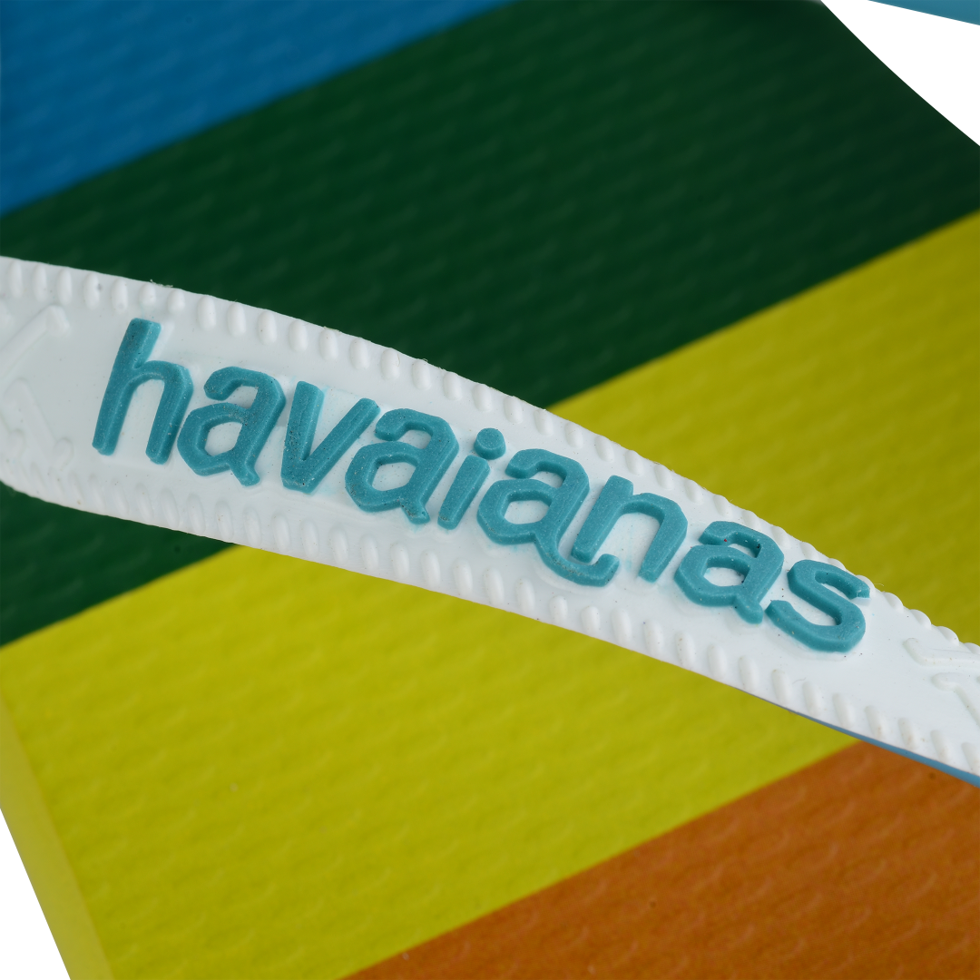 Rainbow stripe flip flops with white straps and blue logo detail view