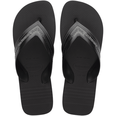 black sandals with rice patterned grooves and striped grooves on the footbed, with black straps and a grey stitched like pattern, top view