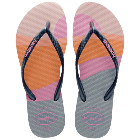 Kid's multicolor abstract print of sunset over the horizon of waves flip flops with navy glitter straps and pink logo top view