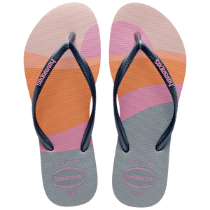 Kid's multicolor abstract print of sunset over the horizon of waves flip flops with navy glitter straps and pink logo top view