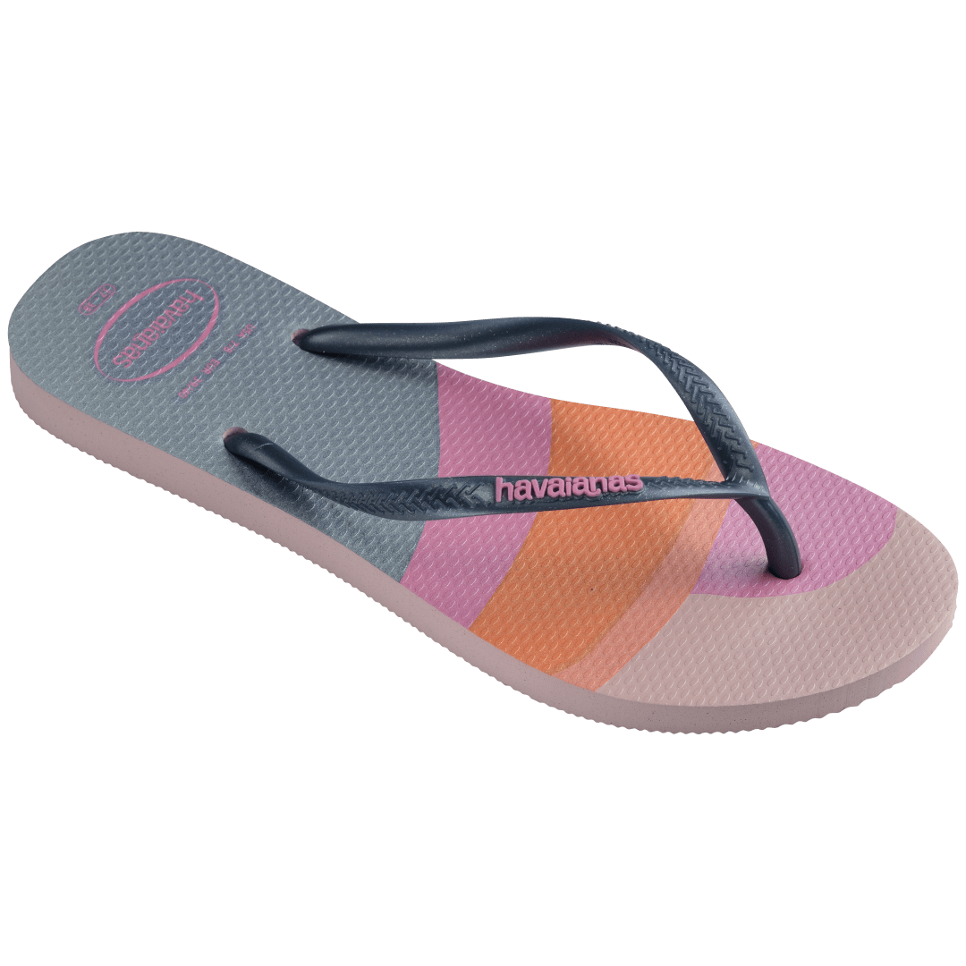 Women's multicolor abstract print of sunset over the horizon of waves flip flops with navy glitter straps and pink logo 3/4 side view