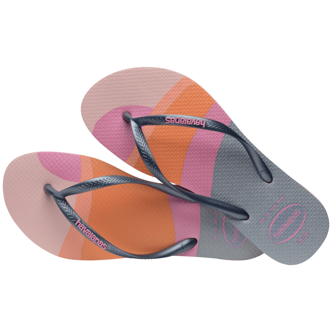 Kid's multicolor abstract print of sunset over the horizon of waves flip flops with navy glitter straps and pink logo alternate top view