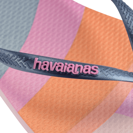 Women's multicolor abstract print of sunset over the horizon of waves flip flops with navy glitter straps and pink logo detail view