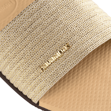 women's beige slide with tonal metallic upper gold logo detail view