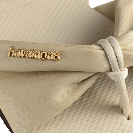 Women's cream sandal with bow detail, logo detail view