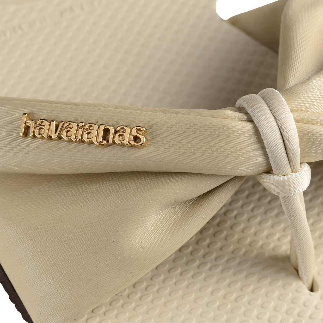 Women's cream sandal with bow detail, logo detail view