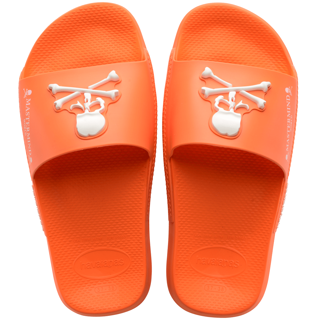 Men's Mastermind orange slides with white skull & cross-bones, top view