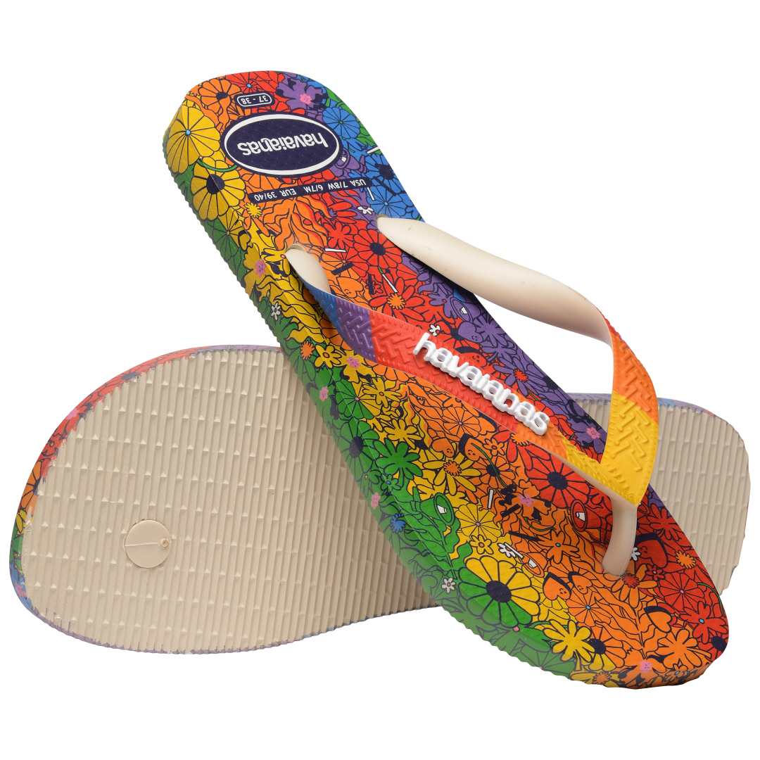 Rainbow floral flip flops with one perched on the other one