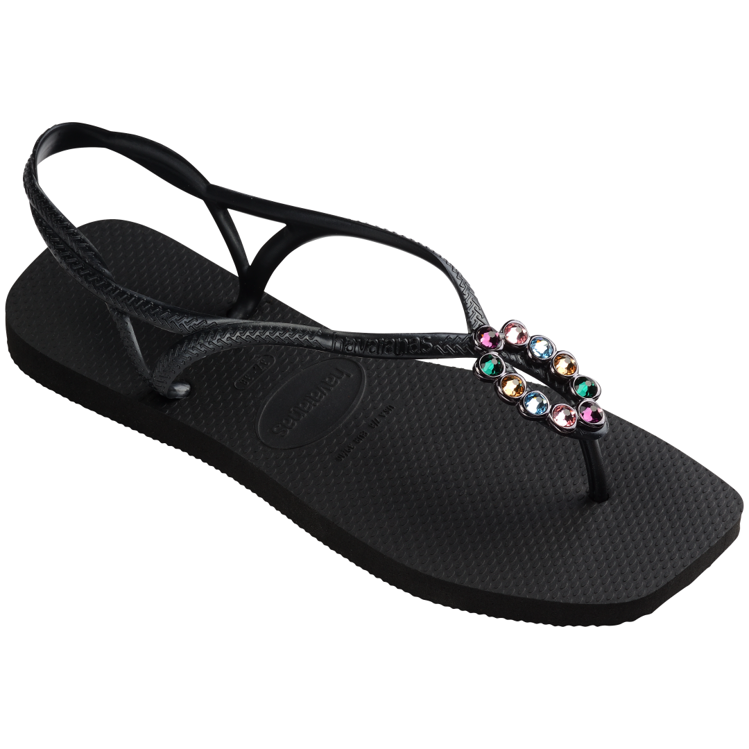 Women's black sandal featuring oval with multicolor crystal details  3/4 side view