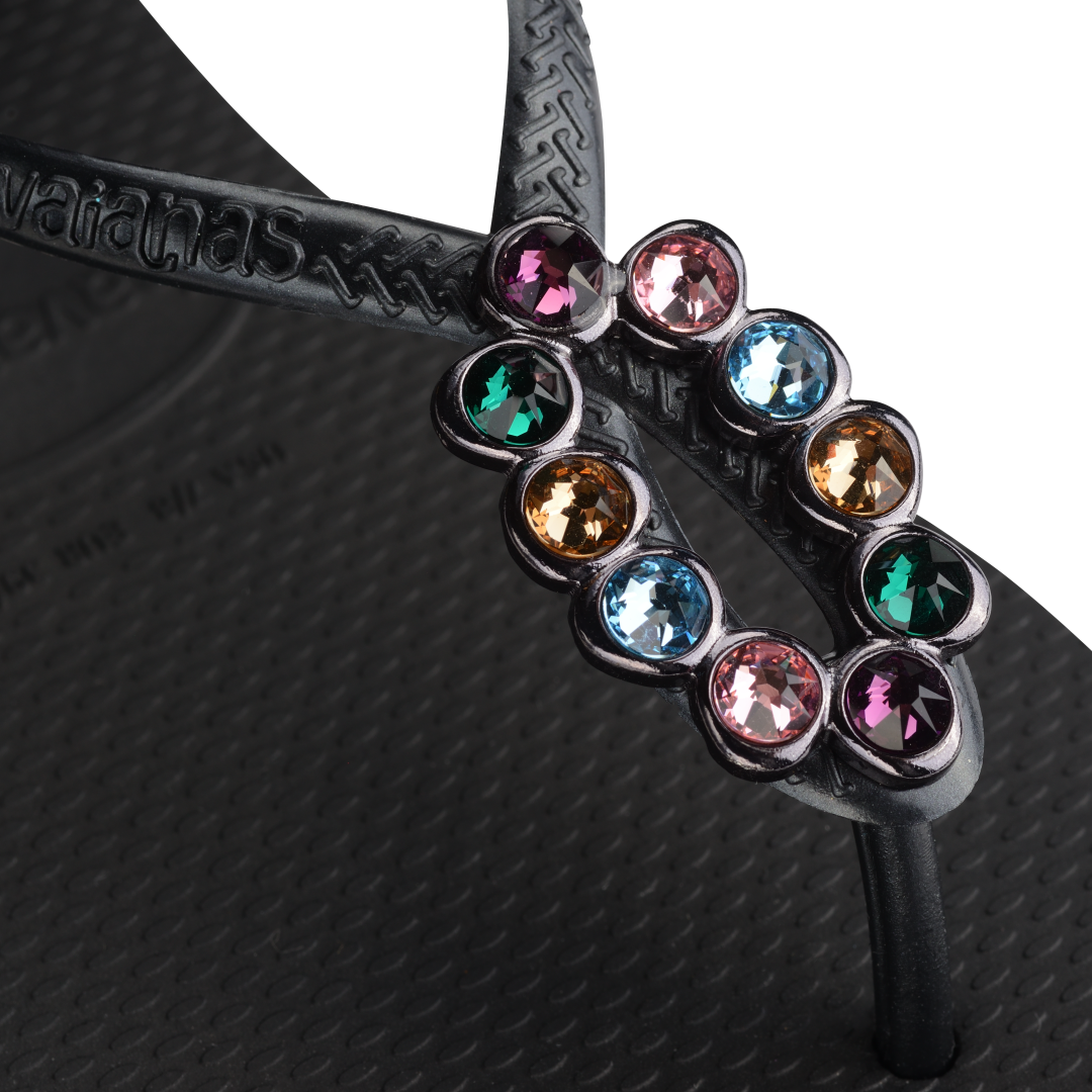 Women's black sandal featuring oval with multicolor crystal detail view