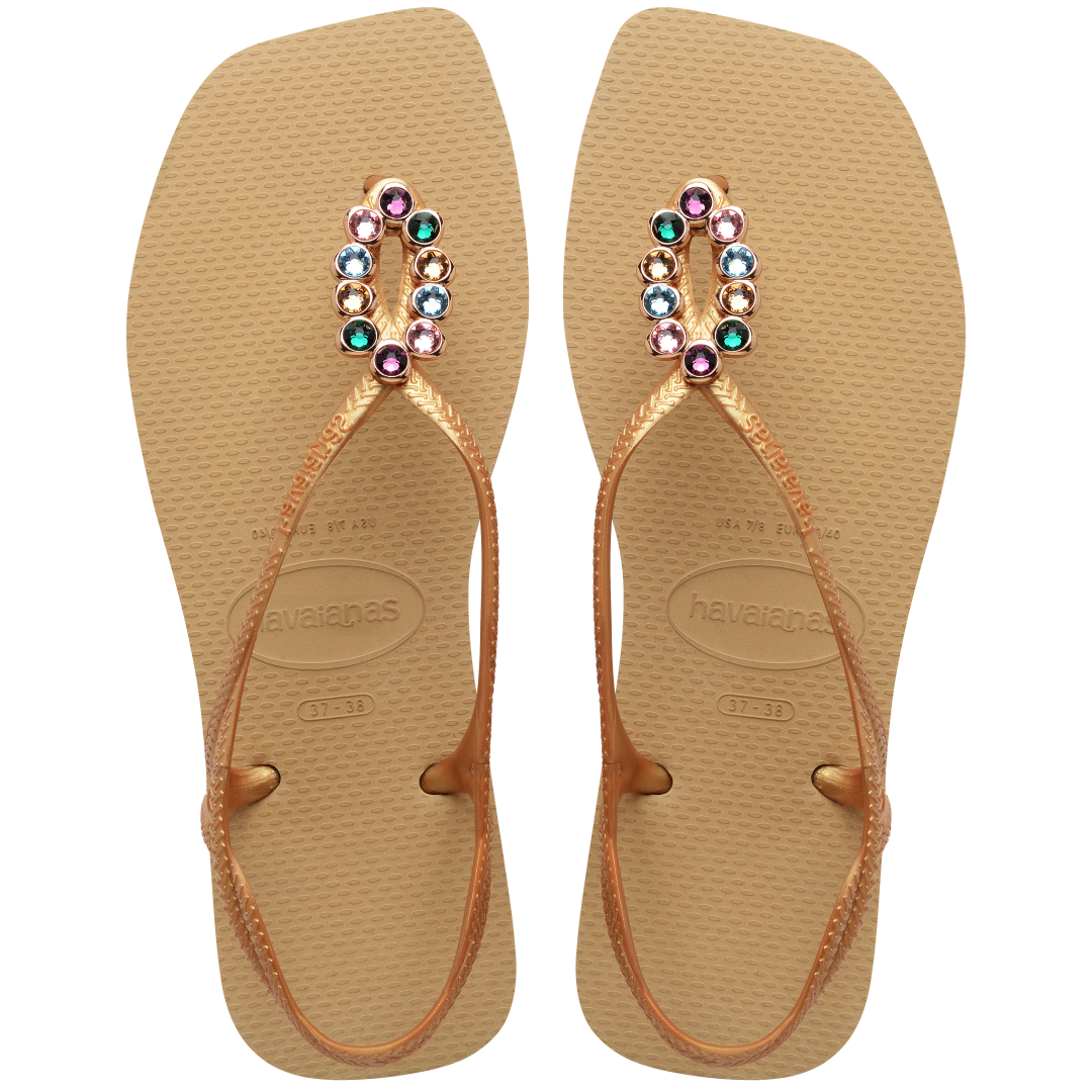 Women's tan sandal with oval multicolor crystal decoration and gold straps, top view