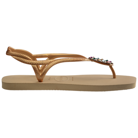 Women's tan sandal with oval multicolor crystal decoration and gold straps, side view