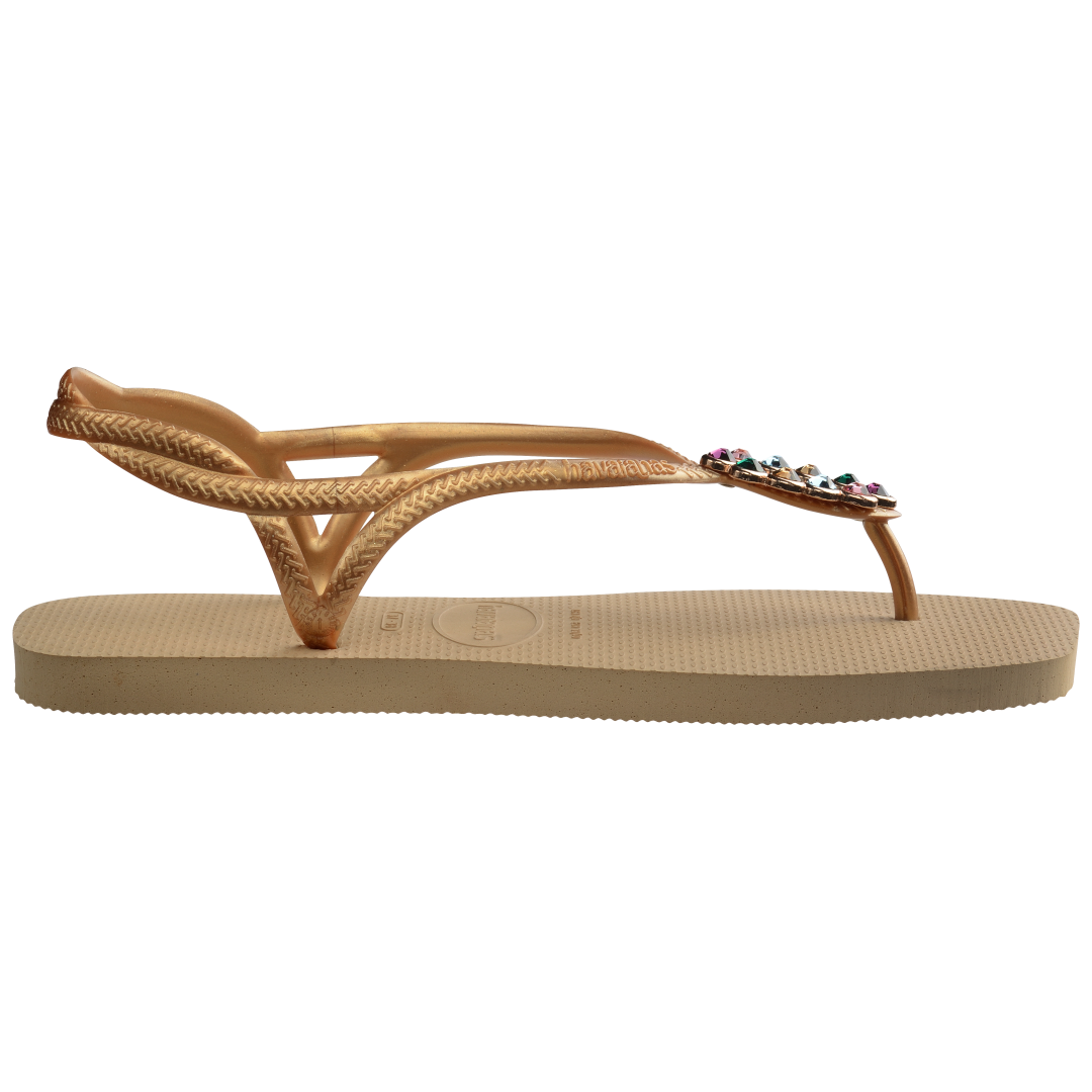 Women's tan sandal with oval multicolor crystal decoration and gold straps, side view