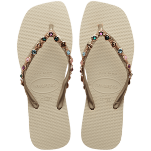 Women's square toe cream flip flops and gold straps with multicolor crystals, top view