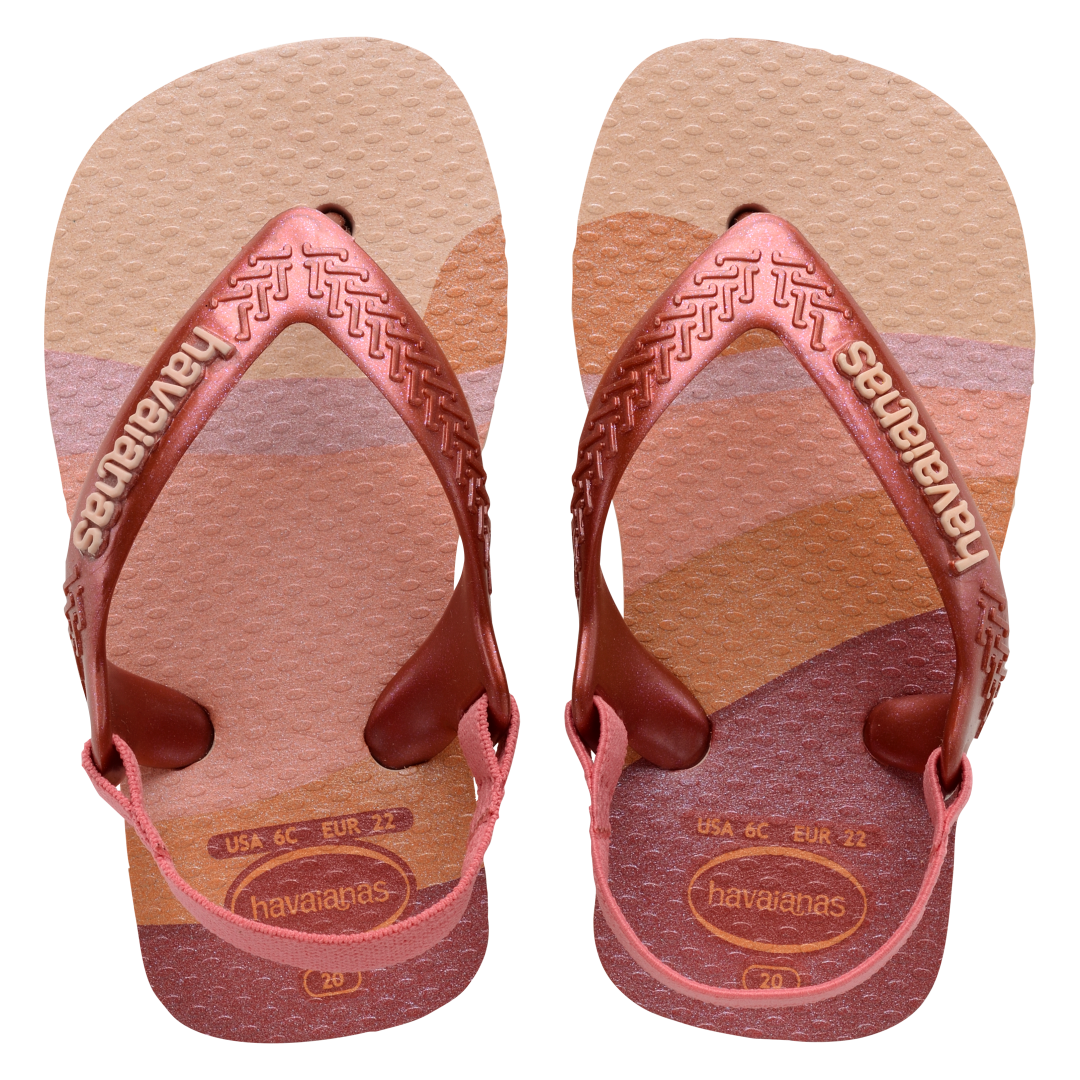 Baby flip flops with backstrap, abstract pink, beige and orange print with metallic pink straps, top view