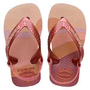 Baby flip flops with backstrap, abstract pink, beige and orange print with metallic pink straps, top view