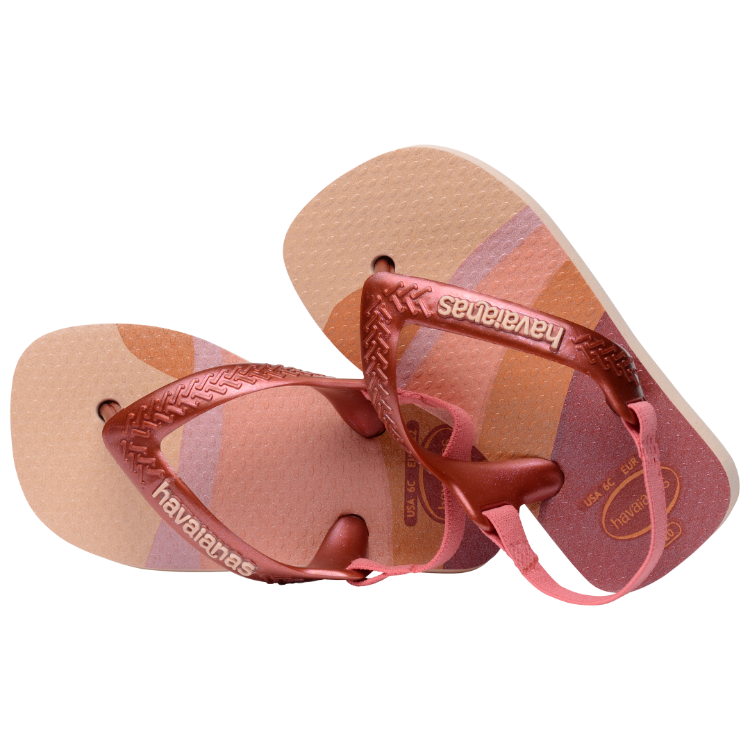 Baby flip flops with backstrap, abstract pink, beige and orange print with metallic pink straps, front view