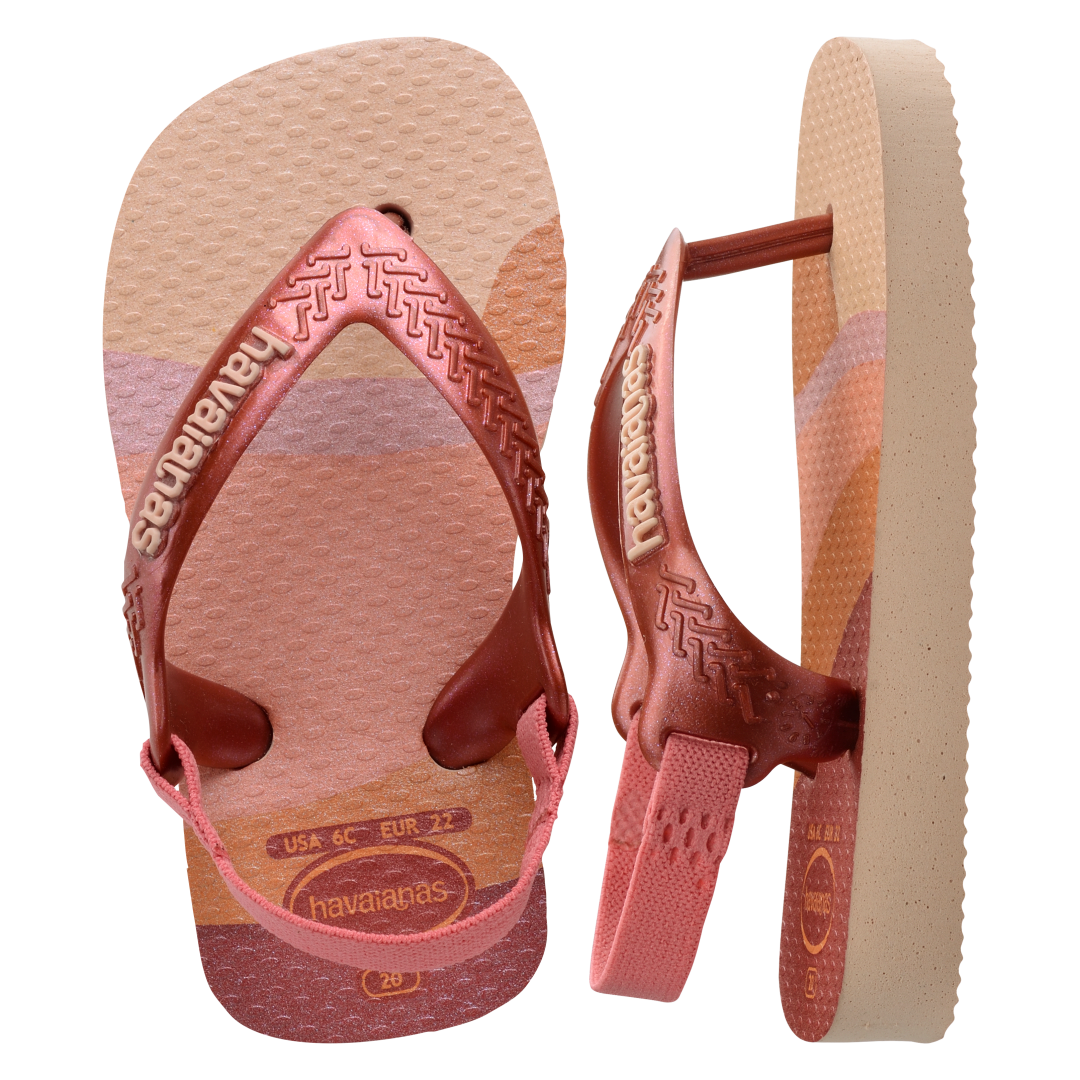 Baby flip flops with backstrap, abstract pink, beige and orange print with metallic pink straps, one top view and the other side view