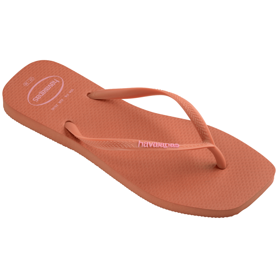 square-toe flip flop in orange color with pink havaianas logo on the strap, top front-diagonal facing