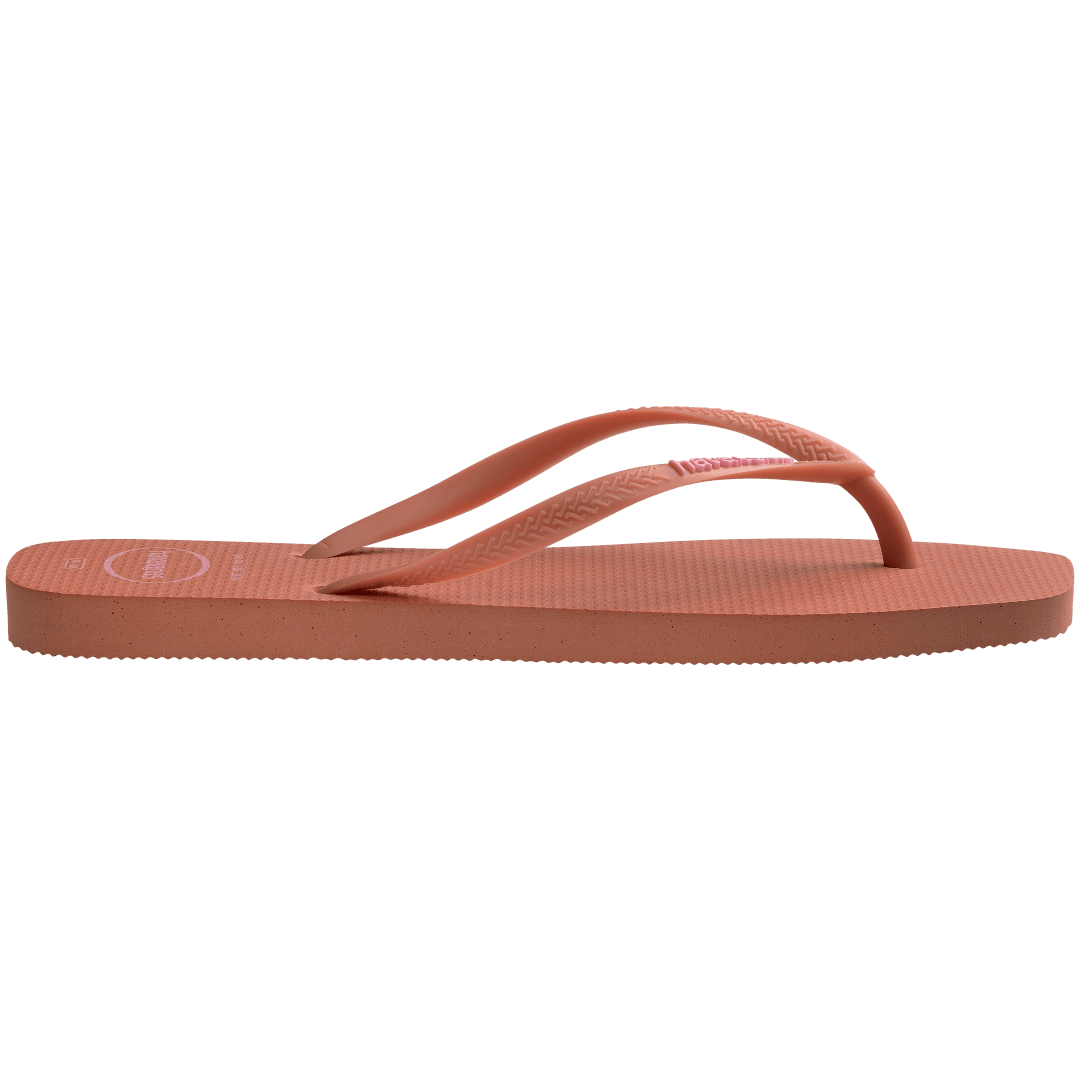 square-toe flip flop in orange color with pink havaianas logo on the strap, side facing