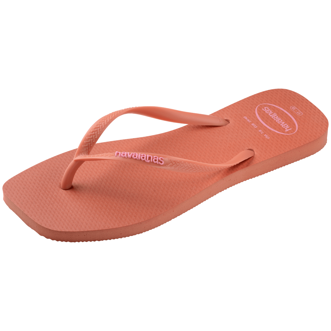 square-toe flip flop in orange color with pink havaianas logo on the strap, front-diagonal facing