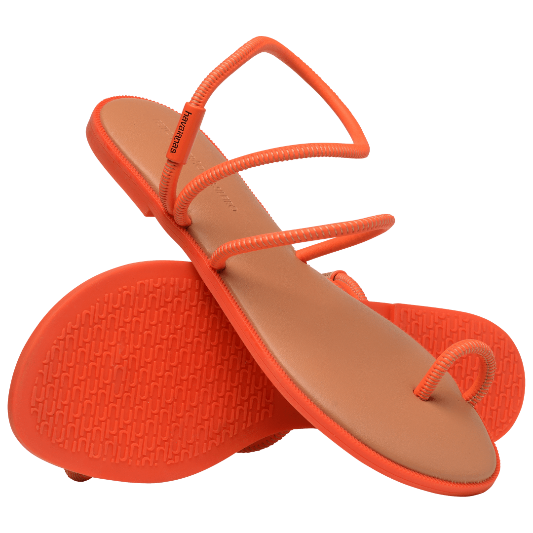 Women's orange strappy sandal, showing darker orange sole with other sandal perched on top