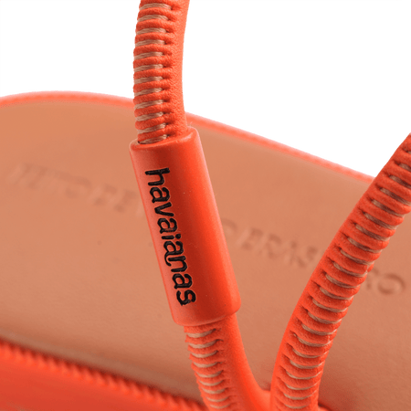 Women's orange strappy sandal logo detail view